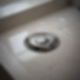 Close-up of a clean bath drain showing shiny metal.