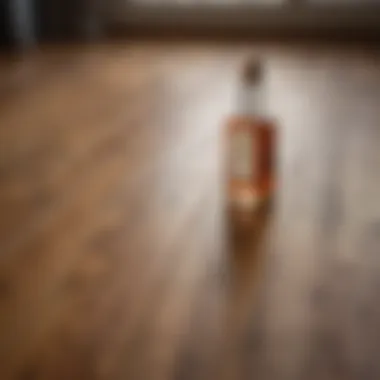 A bottle of vinegar next to a wooden floor showcasing its natural shine