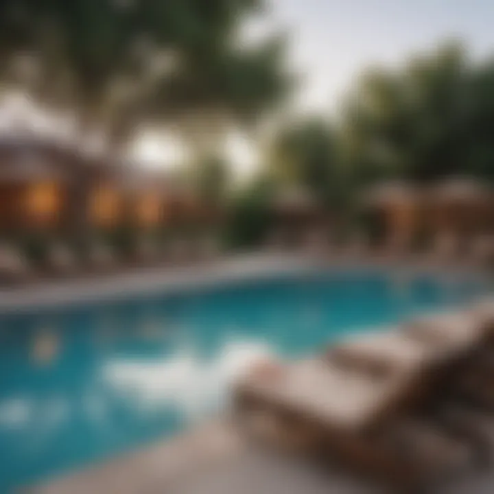 Community pool area with lounge chairs and greenery