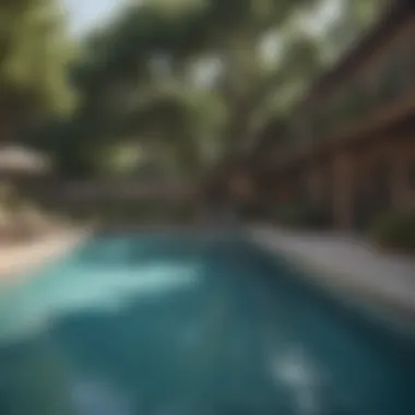 Resort-style pool in the Oak Tree Apartments complex surrounded by greenery