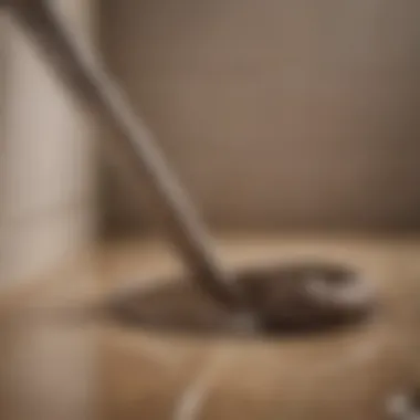 Plumber using a snake tool to unclog a drain